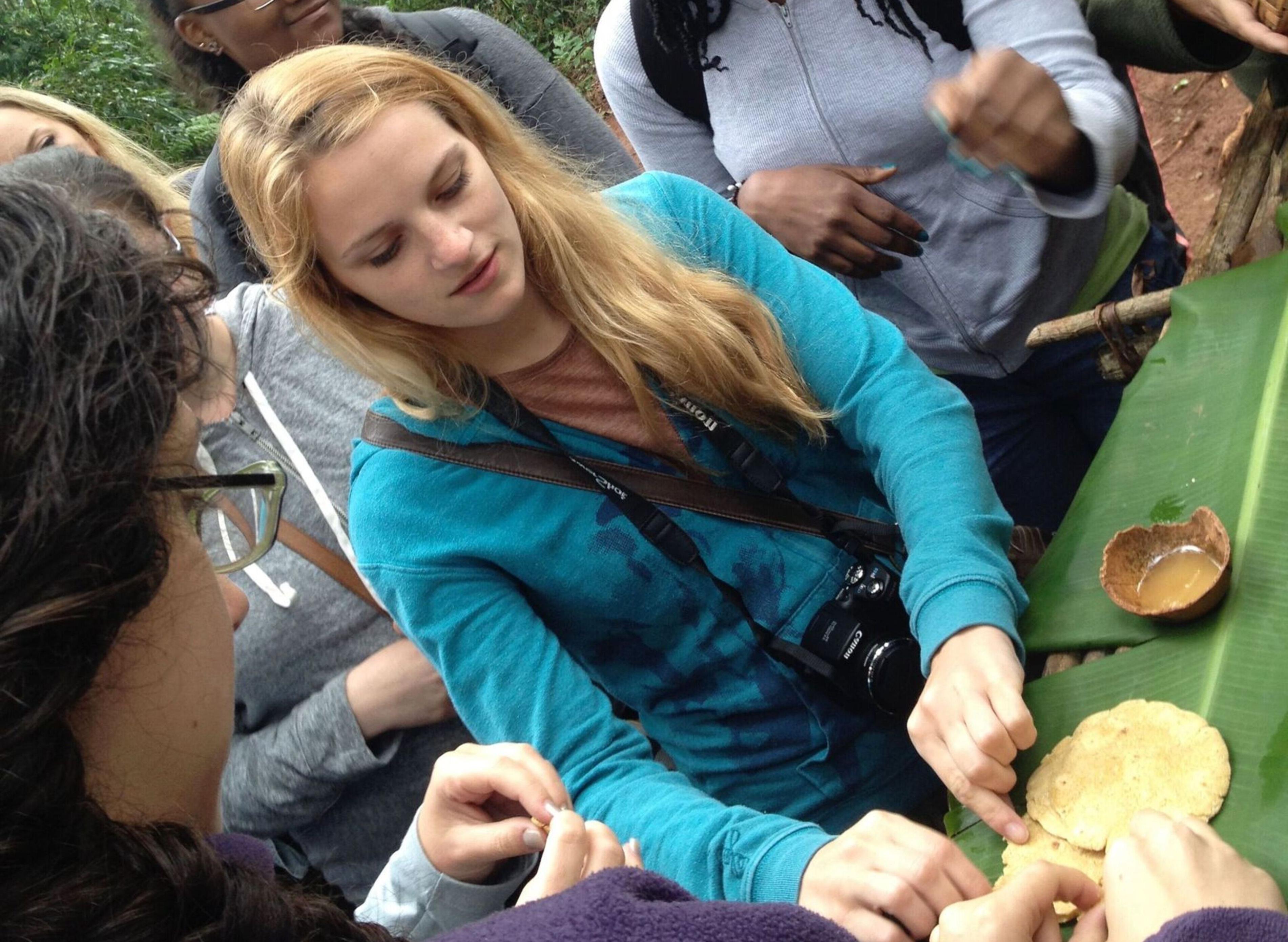 A student exams plant biology in a wooded area